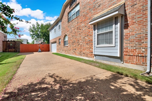 3217 Tearose Dr, Richardson, TX 75082 - view of side of home with brick siding, an attached garage, and concrete driveway