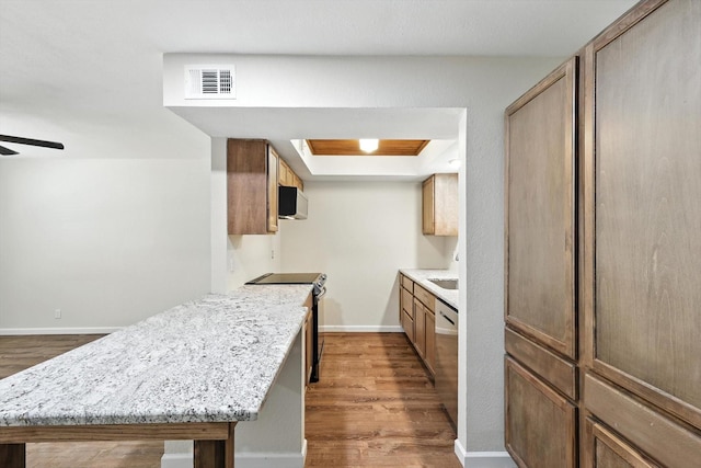 900 W Mulberry St Unit 7, Denton, TX 76201 - kitchen with appliances with stainless steel finishes, dark wood-type flooring, a peninsula, and a ceiling fan