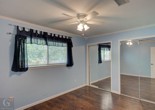 613 Pine Cone Dr, Haughton, LA 71037 - unfurnished bedroom featuring two closets, ornamental molding, wood finished floors, and ceiling fan