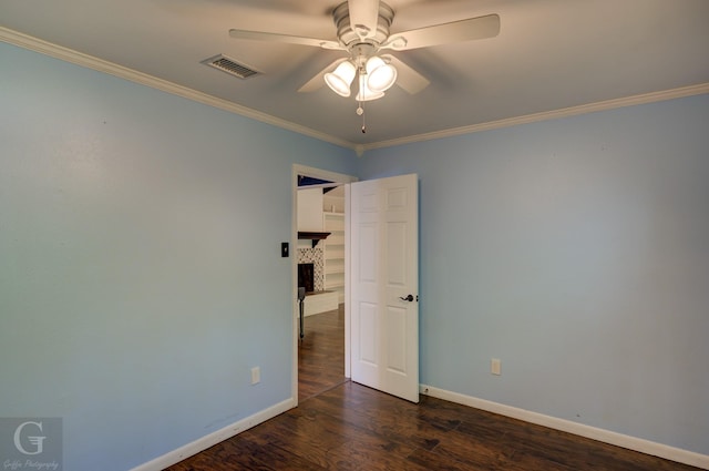 613 Pine Cone Dr, Haughton, LA 71037 - unfurnished room featuring a ceiling fan, crown molding, dark wood-type flooring, and a tiled fireplace