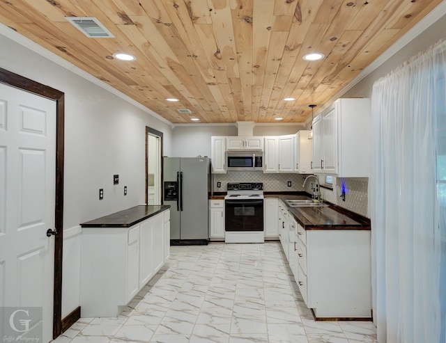 613 Pine Cone Dr, Haughton, LA 71037 - kitchen with stainless steel appliances, recessed lighting, light marble finish floors, dark countertops, and ornamental molding