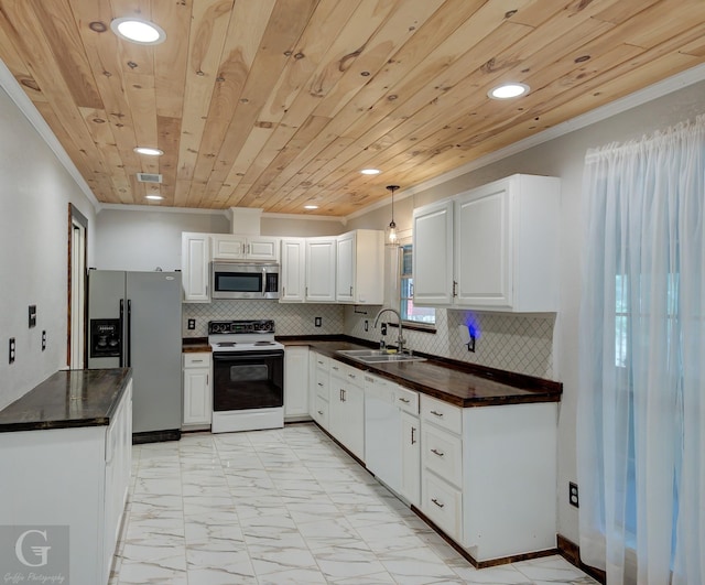 613 Pine Cone Dr, Haughton, LA 71037 - kitchen with appliances with stainless steel finishes, dark countertops, crown molding, light marble finish floors, and recessed lighting