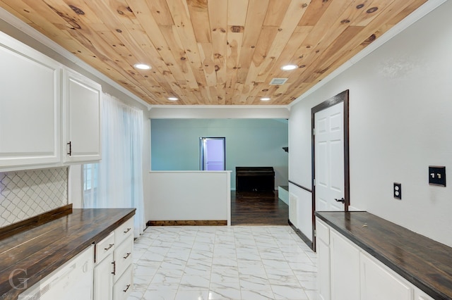 613 Pine Cone Dr, Haughton, LA 71037 - kitchen with recessed lighting, crown molding, wood counters, white cabinets, and backsplash
