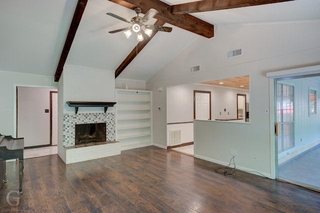 613 Pine Cone Dr, Haughton, LA 71037 - unfurnished living room with a ceiling fan, wood finished floors, a tile fireplace, beam ceiling, and high vaulted ceiling