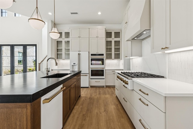 4930 Magnolia Trl, Midlothian, TX 76065 - kitchen featuring premium range hood, white appliances, light wood-type flooring, decorative backsplash, and recessed lighting