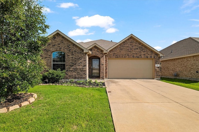 813 Evergreen St, Princeton, TX 75407 - view of front of house with an attached garage, concrete driveway, a front lawn, and brick siding
