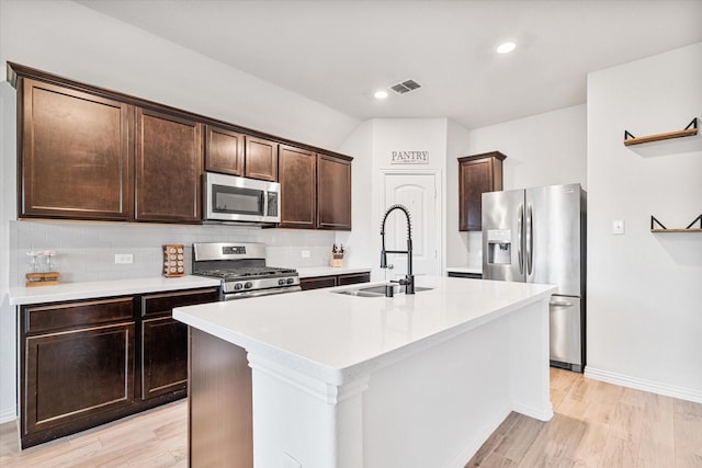 813 Evergreen St, Princeton, TX 75407 - kitchen with appliances with stainless steel finishes, light wood finished floors, dark brown cabinets, and recessed lighting