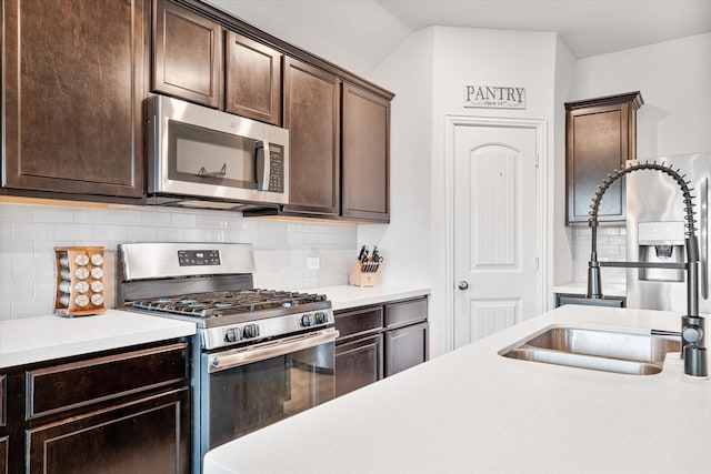 813 Evergreen St, Princeton, TX 75407 - kitchen with appliances with stainless steel finishes, dark brown cabinetry, light countertops, and decorative backsplash