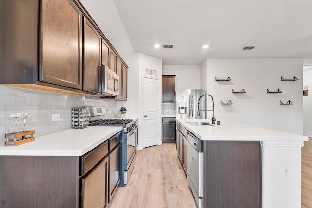 813 Evergreen St, Princeton, TX 75407 - kitchen with appliances with stainless steel finishes, light wood-style flooring, tasteful backsplash, and recessed lighting