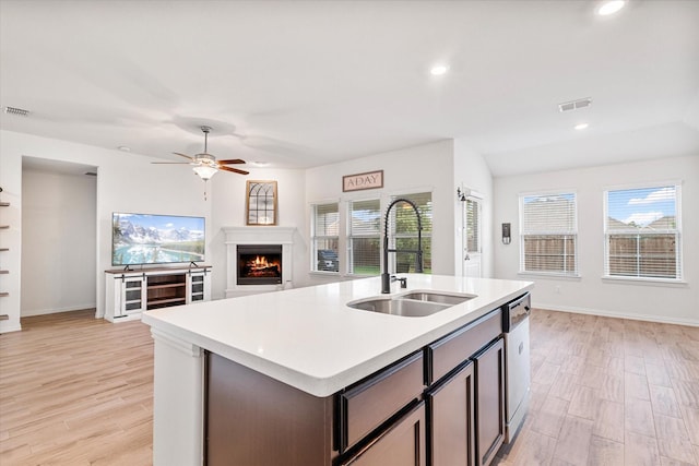 813 Evergreen St, Princeton, TX 75407 - kitchen with open floor plan, light countertops, light wood finished floors, a warm lit fireplace, and recessed lighting