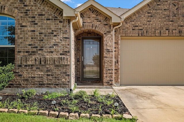 813 Evergreen St, Princeton, TX 75407 - property entrance with concrete driveway, a garage, and brick siding