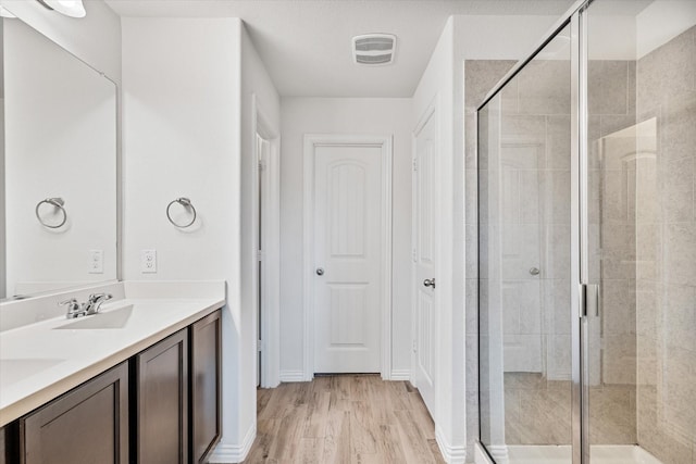 813 Evergreen St, Princeton, TX 75407 - full bath with double vanity, a stall shower, and wood finished floors