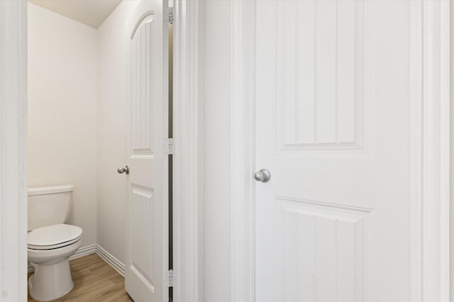 813 Evergreen St, Princeton, TX 75407 - bathroom with toilet and wood finished floors