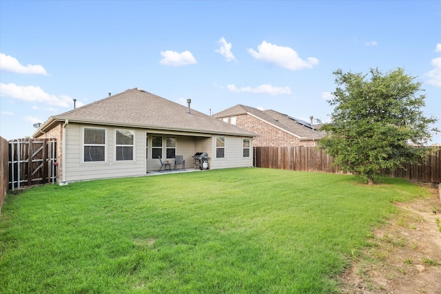 813 Evergreen St, Princeton, TX 75407 - back of property featuring a fenced backyard, a patio, and a shingled roof
