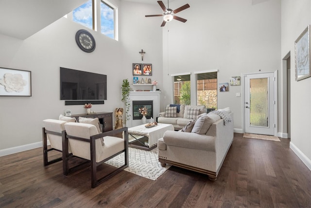 332 Augusta Ct, Oak Point, TX 75068 - living room featuring a towering ceiling, a ceiling fan, dark wood finished floors, and a glass covered fireplace