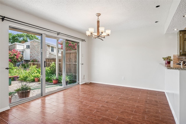 1822 Lakecrest Ct, Carrollton, TX 75006 - spare room with a chandelier, a textured ceiling, and wood finished floors
