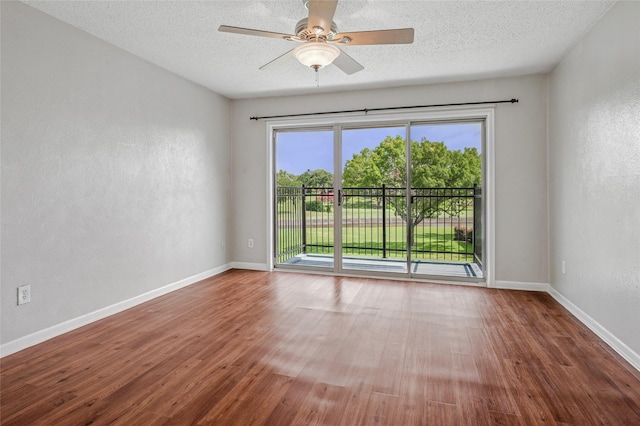 1822 Lakecrest Ct, Carrollton, TX 75006 - empty room featuring wood finished floors, a ceiling fan, a textured ceiling, and a textured wall