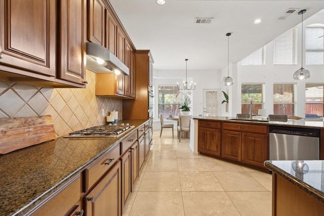 1205 Apache Lake Dr, Carrollton, TX 75010 - kitchen featuring stainless steel appliances, extractor fan, brown cabinets, tasteful backsplash, and recessed lighting