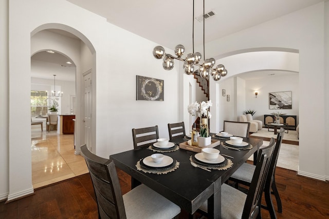 1205 Apache Lake Dr, Carrollton, TX 75010 - dining space with a chandelier, arched walkways, and hardwood / wood-style floors