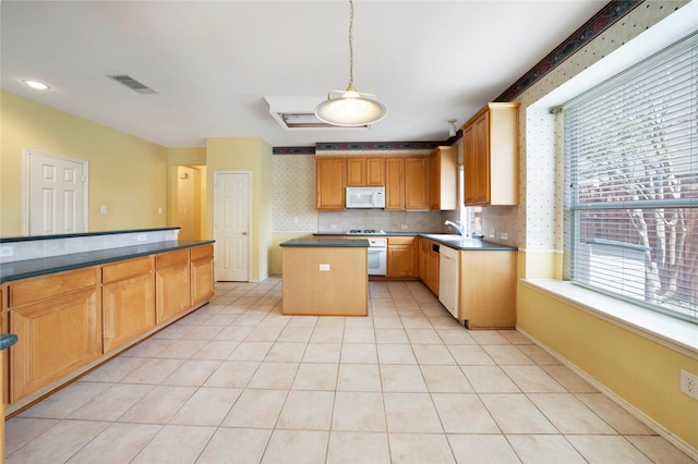 8201 Fountain Ridge Dr, Plano, TX 75025 - kitchen with white appliances, wallpapered walls, a kitchen island, dark countertops, and pendant lighting