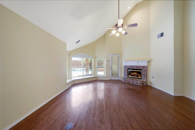8201 Fountain Ridge Dr, Plano, TX 75025 - unfurnished living room with high vaulted ceiling, wood finished floors, a brick fireplace, and ceiling fan