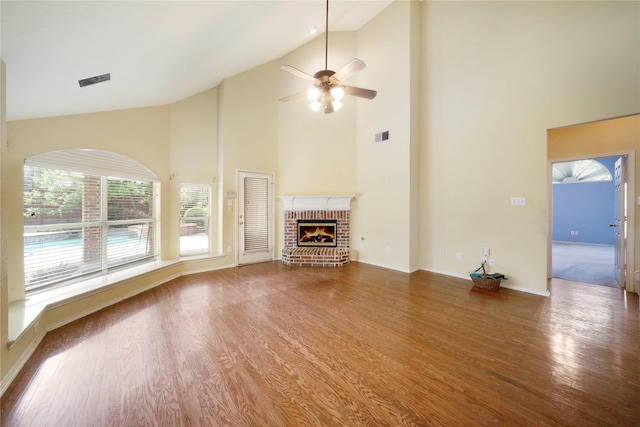 8201 Fountain Ridge Dr, Plano, TX 75025 - unfurnished living room featuring high vaulted ceiling, wood finished floors, a ceiling fan, and a brick fireplace