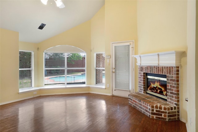 8201 Fountain Ridge Dr, Plano, TX 75025 - unfurnished living room featuring wood finished floors, a brick fireplace, and high vaulted ceiling