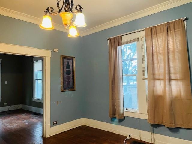 106 Lawrence Ave, Terrell, TX 75160 - spare room with crown molding, a chandelier, and dark wood finished floors