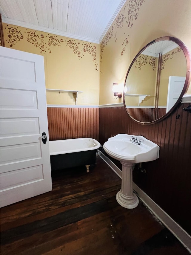106 Lawrence Ave, Terrell, TX 75160 - full bathroom with wainscoting, a freestanding bath, crown molding, hardwood / wood-style flooring, and wood walls