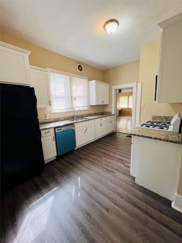 106 Lawrence Ave, Terrell, TX 75160 - kitchen featuring dishwasher, freestanding refrigerator, dark wood finished floors, white cabinetry, and light stone countertops