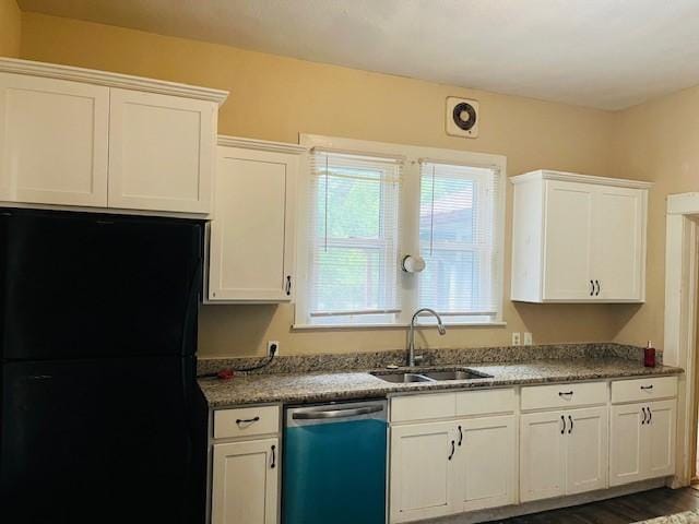 106 Lawrence Ave, Terrell, TX 75160 - kitchen with dishwashing machine, freestanding refrigerator, white cabinetry, and dark wood-style floors