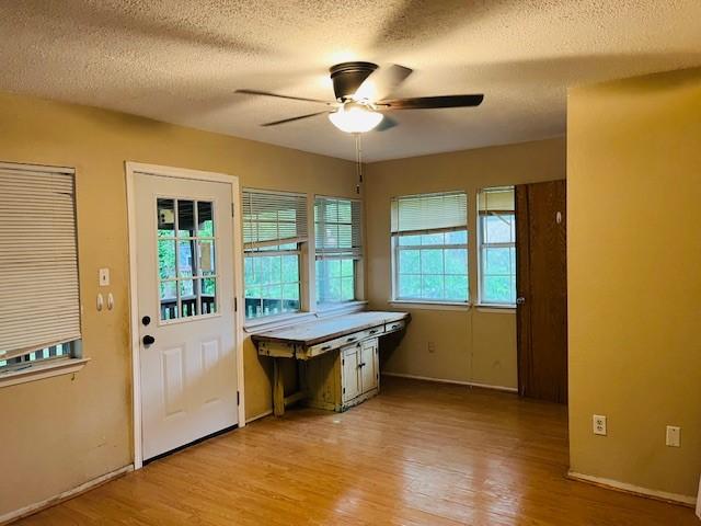 106 Lawrence Ave, Terrell, TX 75160 - unfurnished dining area featuring a ceiling fan, light wood finished floors, and a textured ceiling