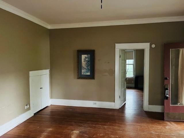 106 Lawrence Ave, Terrell, TX 75160 - unfurnished room featuring crown molding and wood finished floors