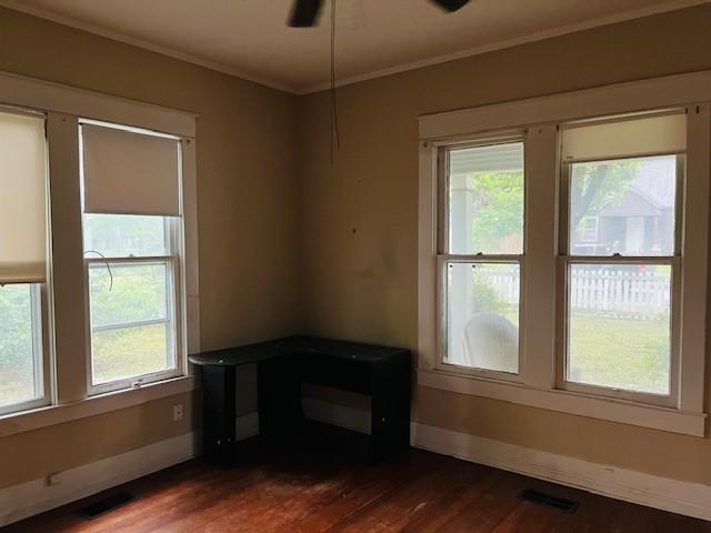 106 Lawrence Ave, Terrell, TX 75160 - spare room featuring healthy amount of natural light, dark wood-style floors, ornamental molding, and ceiling fan
