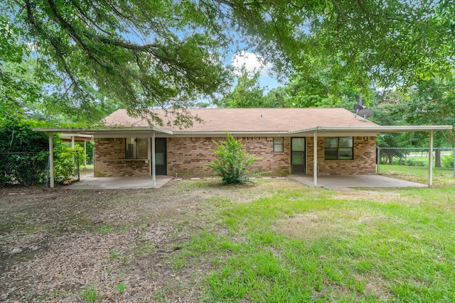 6179 State Highway 31 E, Murchison, TX 75778 - back of property with a patio area and brick siding