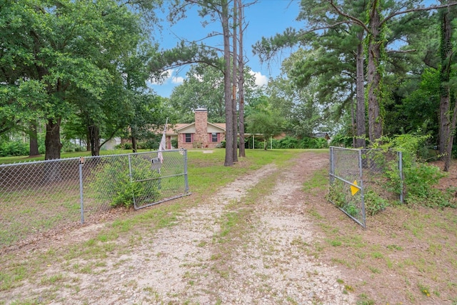 6179 State Highway 31 E, Murchison, TX 75778 - view of dirt / gravel driveway with a gated entry and a gate