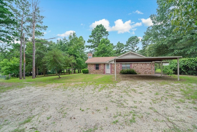 6179 State Highway 31 E, Murchison, TX 75778 - ranch-style house with a chimney, brick siding, a front lawn, and a carport