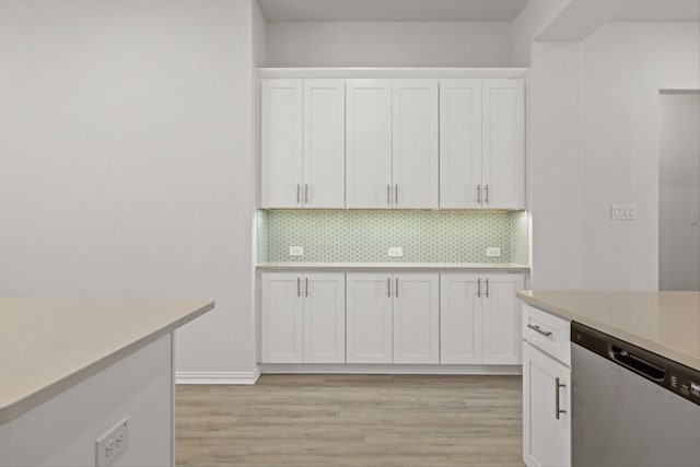 2105 Hazel Lily Run, Mesquite, TX 75181 - kitchen with dishwasher, light countertops, white cabinets, light wood finished floors, and tasteful backsplash