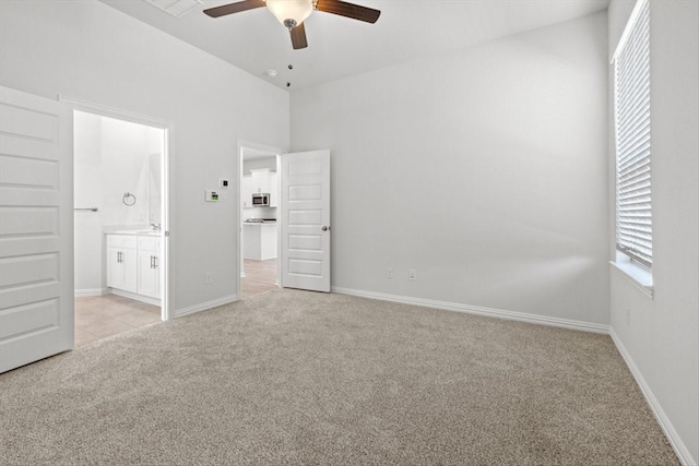 2105 Hazel Lily Run, Mesquite, TX 75181 - unfurnished bedroom featuring light colored carpet, ensuite bathroom, and a ceiling fan
