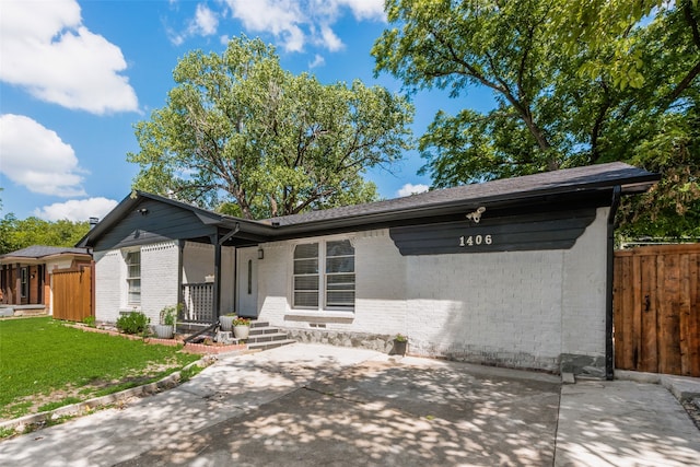 1406 Highland St, Mesquite, TX 75149 - ranch-style home featuring brick siding and a patio area