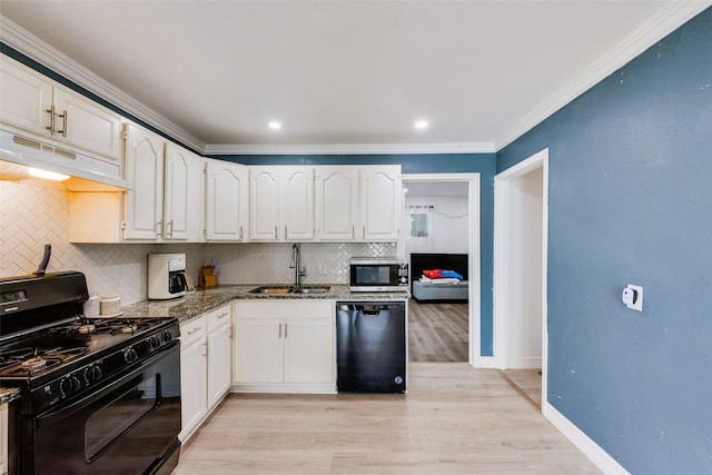 1406 Highland St, Mesquite, TX 75149 - kitchen with black appliances, under cabinet range hood, backsplash, dark stone countertops, and white cabinets