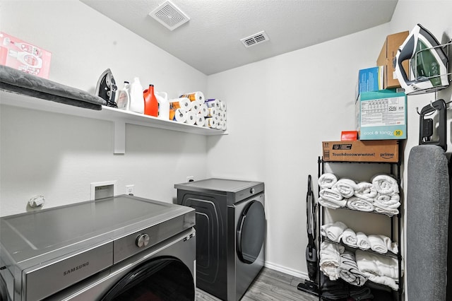 14004 Haggerston Dr, Pilot Point, TX 76258 - laundry area featuring washer and dryer and wood finished floors
