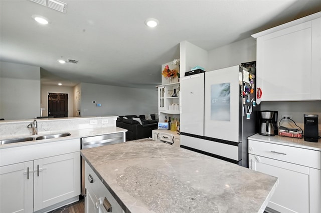 14004 Haggerston Dr, Pilot Point, TX 76258 - kitchen with freestanding refrigerator, white cabinets, recessed lighting, a center island, and open floor plan