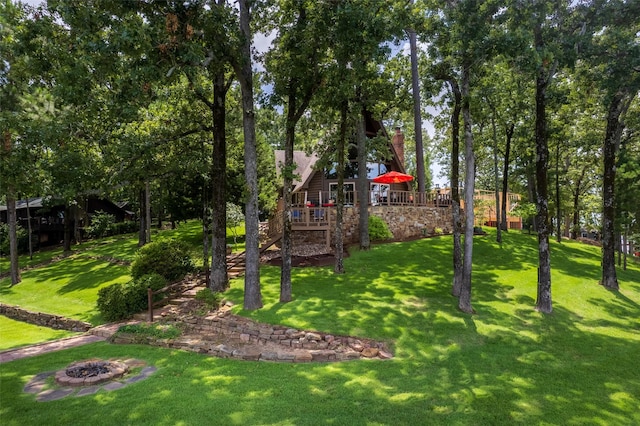 329 Hickory Hill Ln, Scroggins, TX 75480 - view of green lawn featuring a wooden deck, stairs, and a fire pit