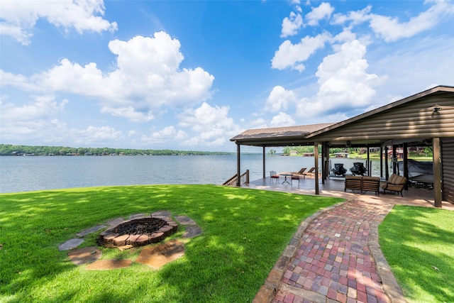 329 Hickory Hill Ln, Scroggins, TX 75480 - dock area with boat lift, an outdoor fire pit, a lawn, and a water view