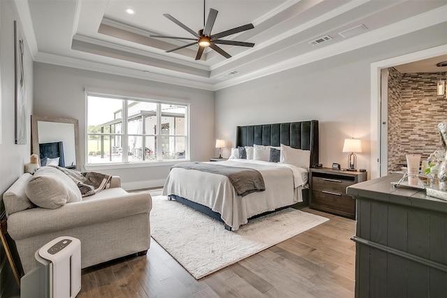 720 Glade Park Ct, Azle, TX 76020 - bedroom with a tray ceiling, ornamental molding, wood finished floors, and a ceiling fan