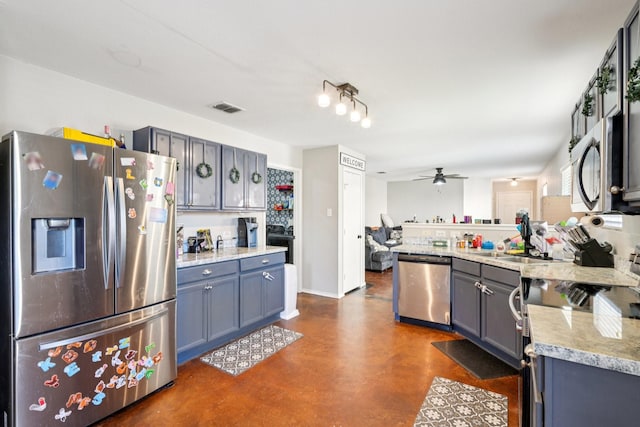 6724 Meadow Way Ln, Fort Worth, TX 76179 - kitchen with stainless steel appliances, concrete floors, ceiling fan, a peninsula, and gray cabinets