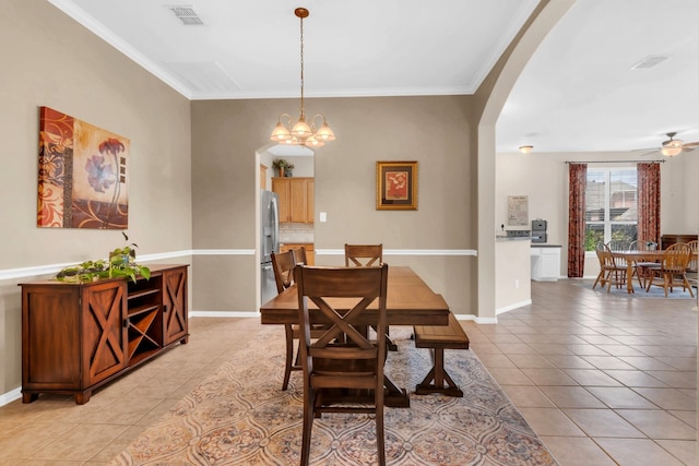 5233 Scenic Point Dr, Fort Worth, TX 76244 - dining area featuring arched walkways, light tile patterned floors, a chandelier, ceiling fan, and crown molding