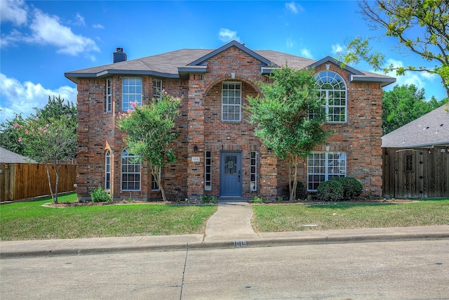 1015 Midnight Pass, Rockwall, TX 75087 - traditional-style house with brick siding and a chimney