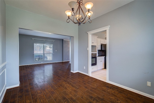 1015 Midnight Pass, Rockwall, TX 75087 - spare room featuring a chandelier and wood finished floors